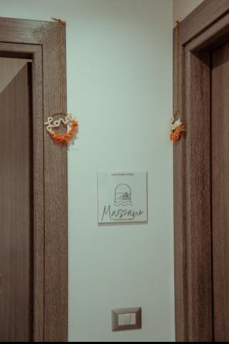 a sign on a wall next to a door at Massanè Casa Vacanza in Ginosa