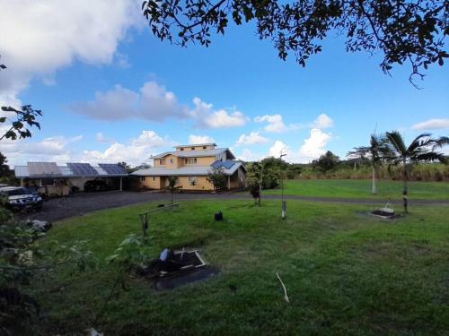 a house in a field with a large yard at Kapoho paradise with pool in Kapoho