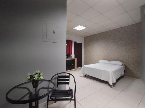 a bedroom with a bed and a table and chairs at Apartamentos Marconela in San Mateo