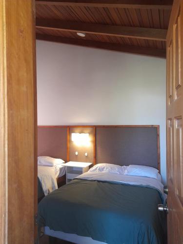 a bedroom with two beds in a room at Bamboo Village Place in Tumbaco
