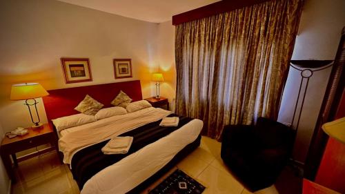 a hotel room with a bed and a window at Tell Madaba in Madaba