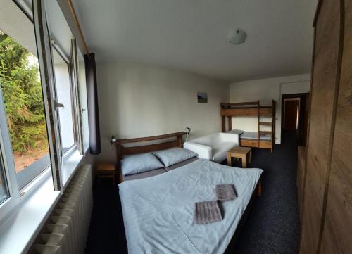 a small bedroom with a bed and a window at Pension Salma in Cerny Dul