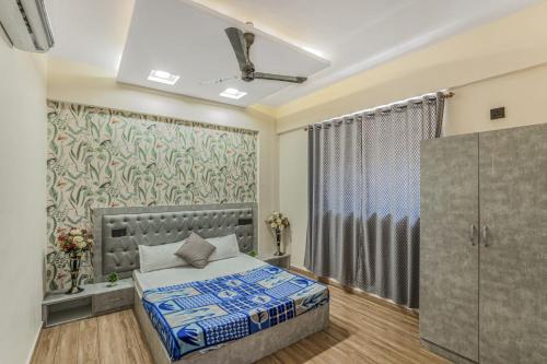 a bedroom with a bed and a curtain at 3BHK with pool - Sunset Palazzo by Universe Villas in Dhamni