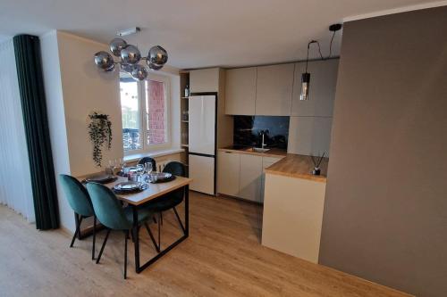 a kitchen with a table and chairs in a room at Apartment vanalinnas in Võru