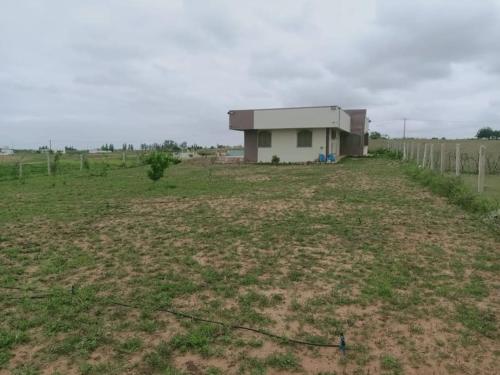a building in the middle of a field at Ferme de Rêve, logement Entier à Louer in Sidi Allal el Bahraoui