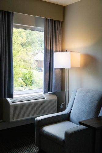 a hotel room with a couch and a window at Twin Mountain Inn & Suites in Pigeon Forge