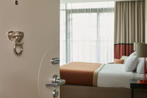 a hotel room with a bed and a window at Hotel Indigo Newcastle by IHG in Newcastle upon Tyne