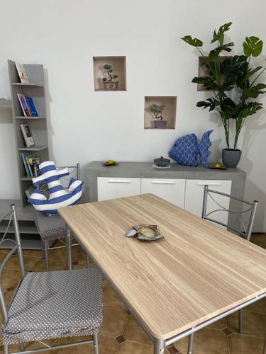 a kitchen with a wooden table with chairs and a counter at Via Roma 55 in Lipari