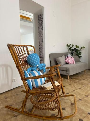 a wooden rocking chair in a living room at Via Roma 55 in Lipari