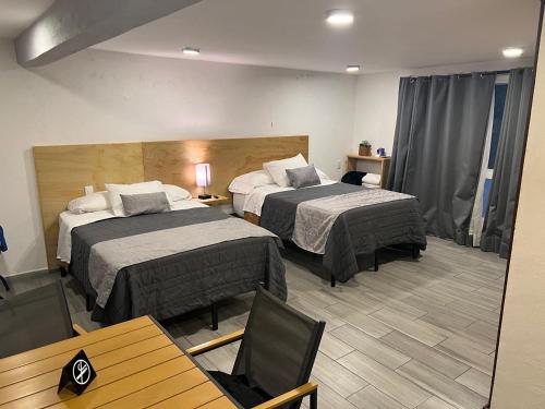 Postel nebo postele na pokoji v ubytování Hotel Ciclovía & Terraza