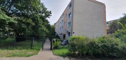 a building with a gate in front of it at Nocleg w Łodzi, Energetyków 1 in Łódź
