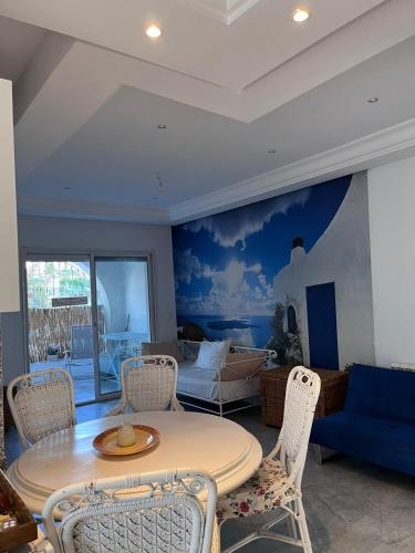 a living room with a table and chairs at Dar Sophie in Hammamet
