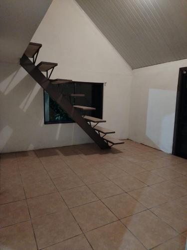 a room with a staircase in a room with a fireplace at Casa de montaña con vista al océano pacífico in Magallanes