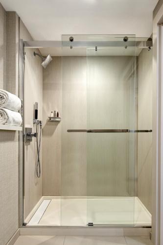 a shower with a glass door in a bathroom at San Francisco Marriott Union Square in San Francisco