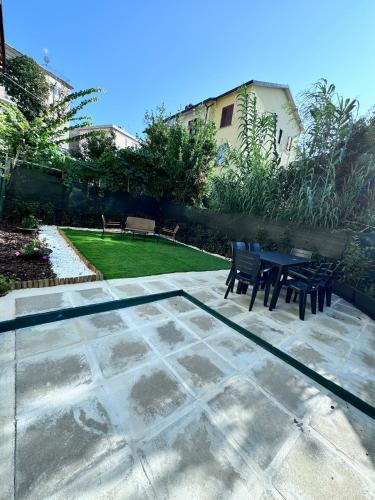 a patio with a table and chairs in a garden at Dama Dama in Guardiagrele