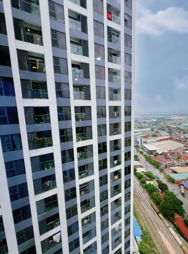 a tall white building with windows and a city at 80m2, 3BR apt - cozy & peaceful - City Center in Hai Phong