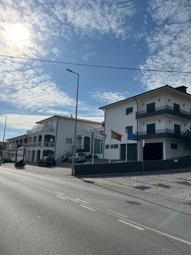 a street with buildings on the side of a road at Ze da Rampa Hotel in Aves