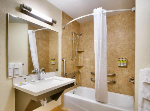 a bathroom with a sink and a shower at Candlewood Suites Plano East by IHG in Plano