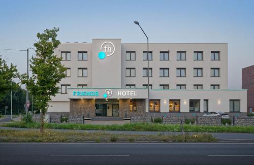 a hotel building with a hotel sign in front of it at Friends Hotel Düsseldorf-Airport Ratingen in Ratingen