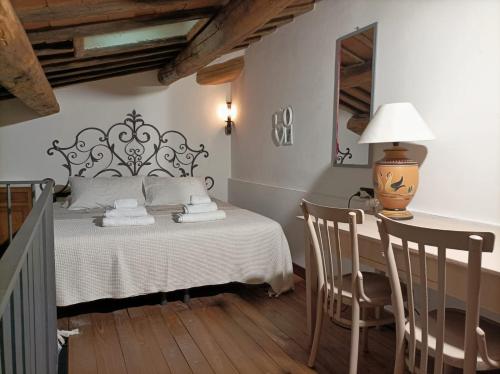 a bedroom with a bed and a table and chairs at Tuscan rooms in Greve in Chianti