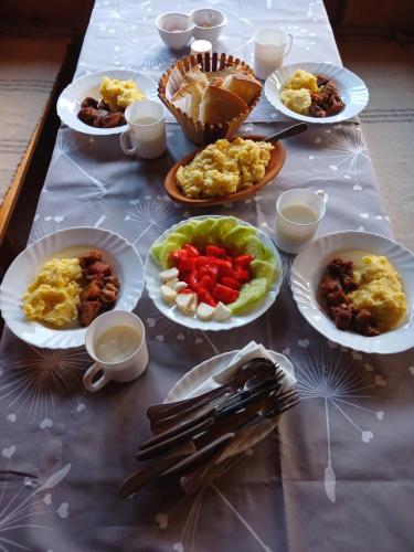 a table with plates of food on top of it at Dulović - KATUN POTOCI in Kolašin