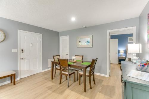 a kitchen and dining room with a table and chairs at Upscale St Simons Condo Sunroom and Steps to Pool! in Island Retreat