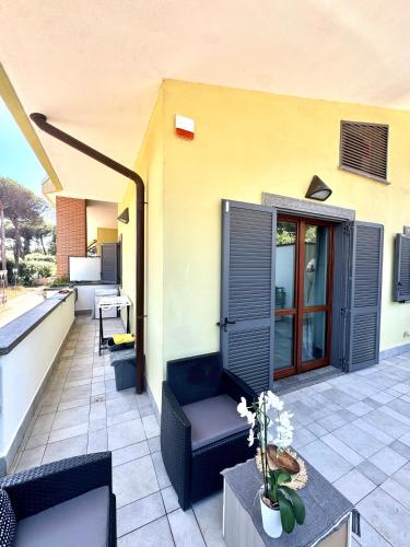 an outdoor patio with a chair and a table at Casa nel verde di Casal Palocco Roma in Casal Palocco