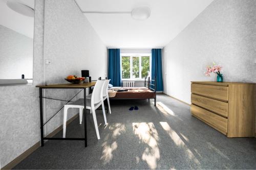 a room with a desk and a table with chairs at Хостел єЖитло Щекавиця in Kyiv