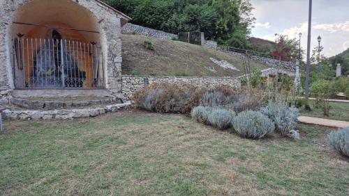 a garden with a gate and a bunch of plants at Amazing Lake View in Castel di Tora