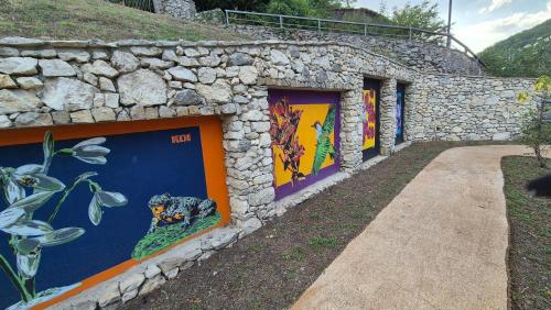 a wall with paintings on the side of a building at Amazing Lake View in Castel di Tora