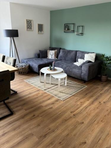 a living room with a couch and a table at Rathauswiese Ferienwohnung in Braunlage