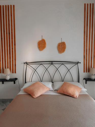 a bedroom with a bed with two pillows on it at La casa di Michelle in Foggia
