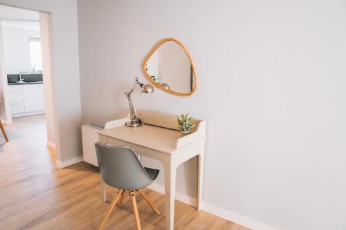 a dressing table with a mirror and a chair at RR - NEW - Beautiful Apartment 80qm - Lift - WIFI in Kröllwitz