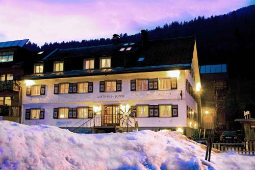 a building with a pile of snow in front of it at Apartments in Bezau - Vorarlberg 41140 in Bezau
