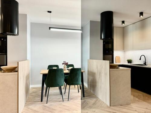 a kitchen and dining room with a table and chairs at Jasielska Apartamenty - Komfortowy Nocleg Poznań in Winiary
