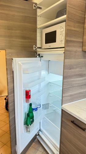 - un réfrigérateur ouvert avec une bouteille à l'intérieur dans l'établissement Frejus Plage F1 bis La Miougrano, à Fréjus