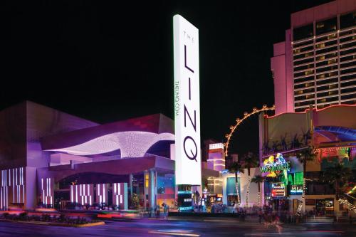 a city at night with a sign that reads hotel at The LINQ Hotel & Casino, A Caesars Destination in Las Vegas