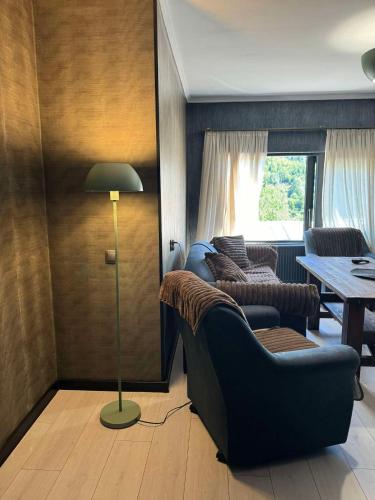 a living room with a couch and a table at Nino Ratiani's Guesthouse in Mestia
