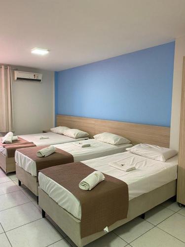 Una cama o camas en una habitación de Executivo Prime Hotel