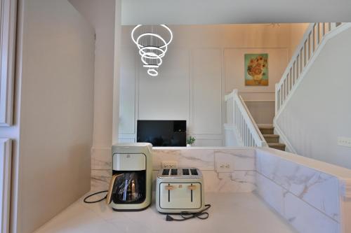 a kitchen with a toaster and a basketball hoop on the wall at Amazing Renovated Townhouse in Greensboro