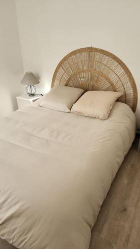 - une chambre avec un grand lit blanc et une tête de lit en bois dans l'établissement Mini villa Favone, à Conca