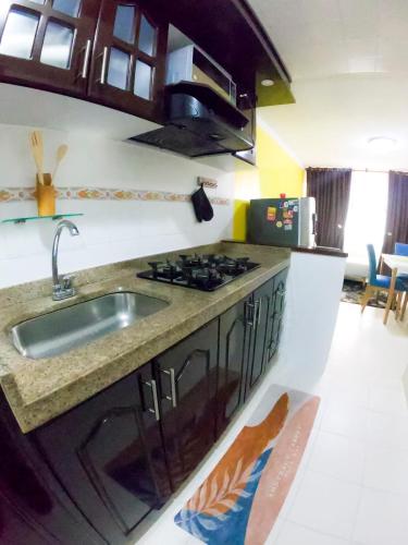 a kitchen with a sink and a stove at Apartamento amplio y acogedor en Bogotá in Bogotá