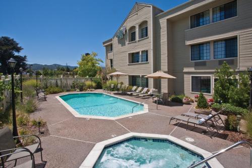 a house with a pool and lawn chairs at Napa Winery Inn in Napa