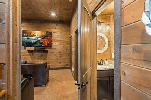 a bathroom with a tub and a sink and a tv at Breathtaking View Mountain Lux Games Pool Theater in Cove Creek Cascades