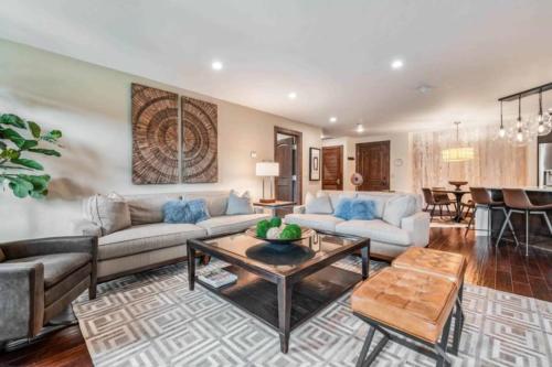 a living room with a couch and a table at Ascent 312 by East West Hospitality in Avon