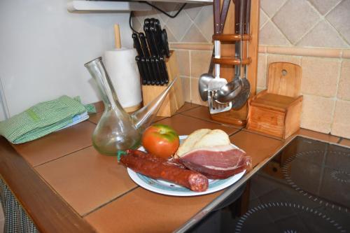 a plate of meat and vegetables on a counter at Casa Rural Nuri de Rei A y B in Todolella