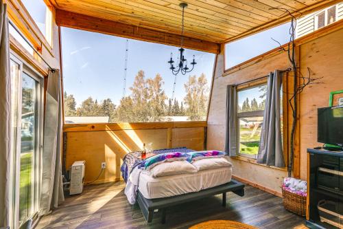 a bedroom with a bed and a large window at Delta Junction Retreat with Northern Lights Cabin! in Delta Junction