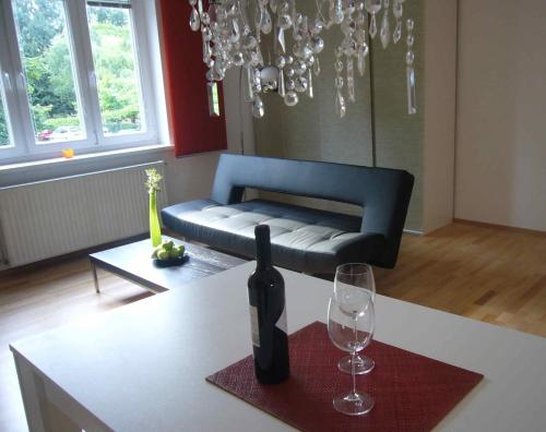 a living room with a couch and a table with wine glasses at Apartment Mödling in Mödling