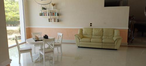 a living room with a couch and a table at Villa Giulia in Siracusa