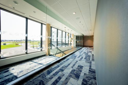 an office hallway with glass doors and a large window at Candlewood Suites Trois-Rivières Ouest by IHG in Trois-Rivières